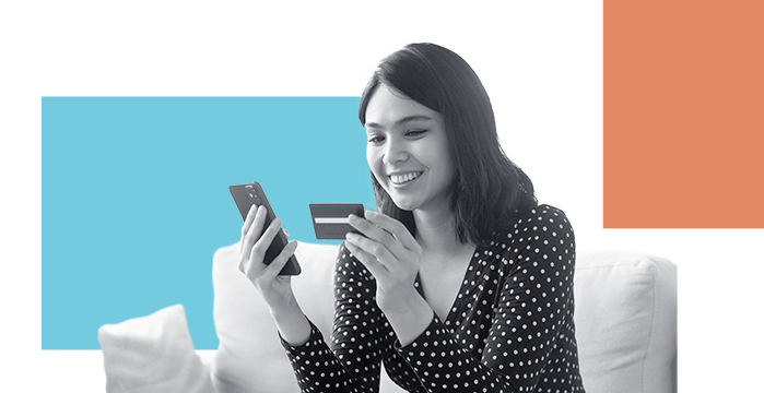 A woman inputing her debit card information into her phone