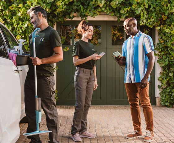 A man using Zelle to cleaners outside his home using the Nationwidetrustuk Bank App